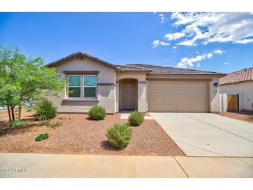Charming single-story home with a well-manicured front yard, desert landscaping, and neutral exterior paint at 1130 E Atwood Dr, Casa Grande, AZ 85122