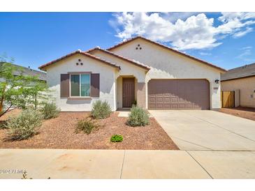 Charming single-story home featuring a two-car garage, neutral stucco, and low-maintenance landscaping at 1142 E Atwood Dr, Casa Grande, AZ 85122
