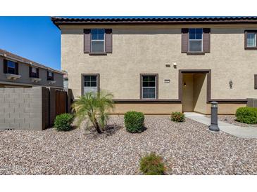Two-story stucco home with brown trim, shutters and desert landscaping at 1265 S Aaron -- # 277, Mesa, AZ 85209