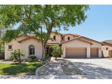 Charming two-story home with a three car garage, lush landscaping, and mature shade tree at 1360 S Camellia Ct, Chandler, AZ 85286