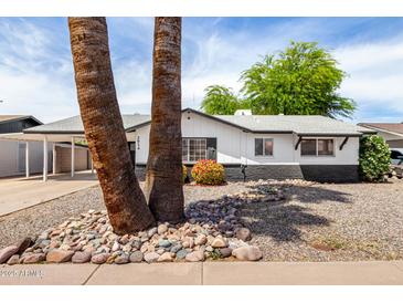 Charming single-story home with black and white trim, desert landscaping, and two large palm trees in front at 2914 W Marlette Ave, Phoenix, AZ 85017