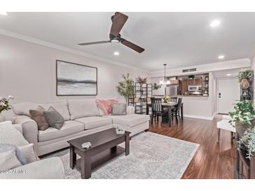 Inviting living room with a plush sectional sofa and stylish decor, perfect for relaxation and entertaining at 4120 N 78Th St # 216, Scottsdale, AZ 85251