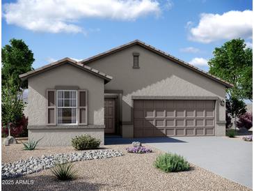 Charming single-story home featuring a desert landscaped yard and an attached two-car garage at 5761 E Iris Dr, Florence, AZ 85132