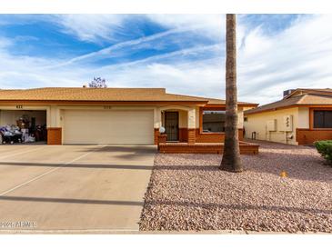 Charming single-story home with a two-car garage, desert landscaping, and a well-maintained front yard at 8255 E Kiva Ave # 420, Mesa, AZ 85209