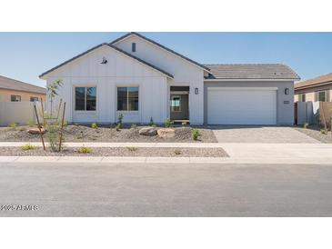Charming single-story home featuring a two-car garage and professionally landscaped front yard at 852 W Golden Ore Pass, Apache Junction, AZ 85120