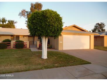 Charming home featuring a well manicured front yard and a two-car garage at 9426 N 109 Th Dr, Sun City, AZ 85351