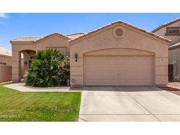 Charming single-story home with a well-maintained lawn and a neutral-toned exterior at 11411 W Dana Ln, Avondale, AZ 85392