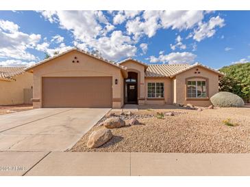 Charming single-story home with a two-car garage, desert landscaping, and neutral exterior paint at 13414 E Cindy St, Chandler, AZ 85225