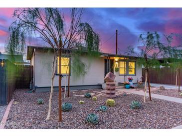 Charming single-story home featuring xeriscaped landscaping with cacti and rock ground cover at 146 E 1St St, Mesa, AZ 85201