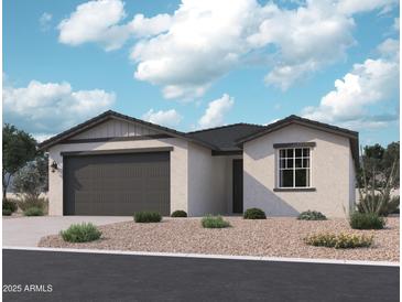 Charming single-story home with a two-car garage and well-maintained desert landscaping at 15792 W Beryl Ave, Waddell, AZ 85355