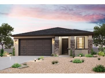 Charming single-story home with stone accents, a two-car garage, and desert landscaping at 22095 N Rummler Ln, Maricopa, AZ 85138