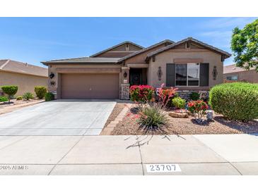 Charming single-story home with desert landscaping, and a two-car garage at 23707 W Hess Ave, Buckeye, AZ 85326
