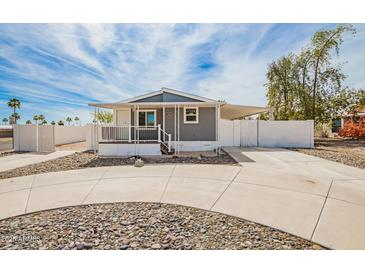 Charming home with covered porch and driveway, surrounded by a decorative rock landscape at 2388 S Vista Rd, Apache Junction, AZ 85119