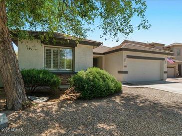 Charming single-story home with a well-manicured front yard and a two-car garage at 271 W Roadrunner Dr, Chandler, AZ 85286