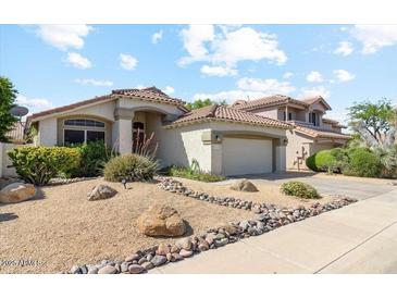 Inviting single-Gathering home with a well-manicured xeriscaped front yard and attached two-car garage at 4223 E Wildcat Dr, Cave Creek, AZ 85331