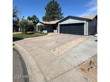Charming single-story home featuring a well-maintained front yard and attached two-car garage at 696 W Shawnee Dr, Chandler, AZ 85225