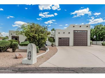 Charming home with a two-car garage, inviting curb appeal, and a well-maintained front yard at 9035 W Villa Chula --, Peoria, AZ 85383