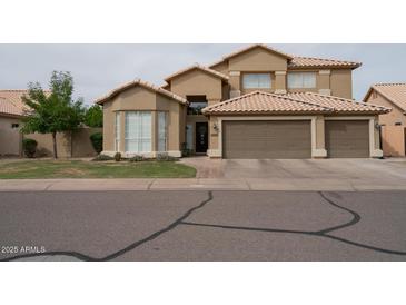 Charming two-story home featuring a three-car garage, neutral stucco and well-maintained landscaping at 1132 E Sheffield Ave, Chandler, AZ 85225