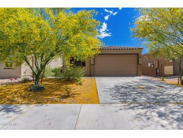 Charming single-story home with beautiful desert landscaping and a spacious two-car garage at 12565 W Palmaire Ave, Glendale, AZ 85307