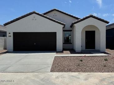 Charming single-story home featuring a well-maintained yard and a two-car garage at 15519 W Deanne Dr, Waddell, AZ 85355