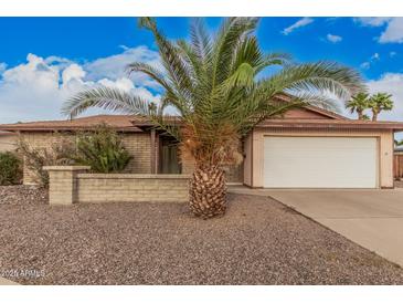 Charming single-story brick home featuring a two-car garage and a desert landscaped front yard at 1857 S El Marino Cir, Mesa, AZ 85202