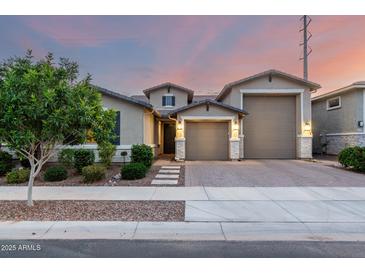 Charming single-story home showcasing a well-manicured lawn, neutral color palette, and a three-car garage at 21408 S 224Th Pl, Queen Creek, AZ 85142