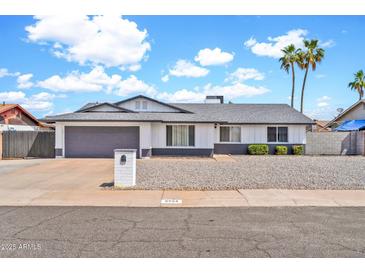 Charming single-story home with a gray roof, a two-car garage, and desert landscaping at 2924 W Anderson Dr, Phoenix, AZ 85053