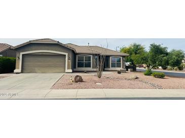 Charming single-story home with desert landscaping, a spacious driveway, and an attached two-car garage at 3176 E Palm Beach Dr, Chandler, AZ 85249