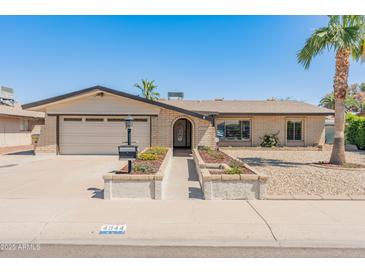 Charming single-story brick home with a well-manicured front yard and attached two-car garage at 4944 W Vista Ave, Glendale, AZ 85301