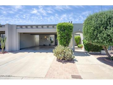 Charming single-story home with a two-car carport, desert landscaping, and a brick pathway at 609 E Royal Palm S Sq, Phoenix, AZ 85020