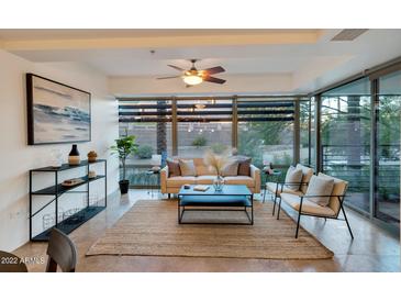 Bright living room with floor to ceiling windows and stylish furniture at 7161 E Rancho Vista Dr # 1013, Scottsdale, AZ 85251