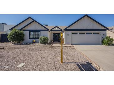 Charming single-story home featuring a well-maintained yard, two-car garage, and inviting front entrance at 717 E Temple St, Chandler, AZ 85225