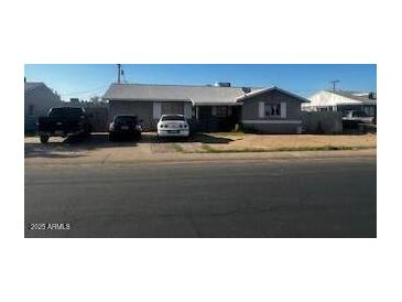Charming single-story home with a well-maintained front yard and ample parking space at 7808 W Clarendon Ave, Phoenix, AZ 85033