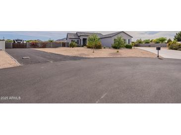 Charming single-story home with a well-maintained desert landscaped front yard and a long driveway at 19029 E Mary Ann Way, Queen Creek, AZ 85142