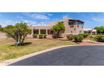A lovely exterior view showcasing a southwestern style home with a stucco facade and mature landscaping at 1954 N Calle Maderas --, Mesa, AZ 85213