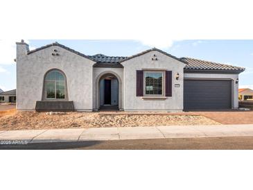 Charming single-story home with a well-manicured front yard and stucco finish at 26914 W Renee Dr, Buckeye, AZ 85396