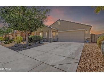 Charming single-story home with a well-maintained yard, desert landscaping, and a spacious driveway at 40061 W Novak Ln, Maricopa, AZ 85138