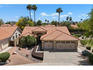 Beautiful desert home featuring a tile roof, three-car garage, and professional desert landscaping at 4625 E Villa Maria Dr, Phoenix, AZ 85032