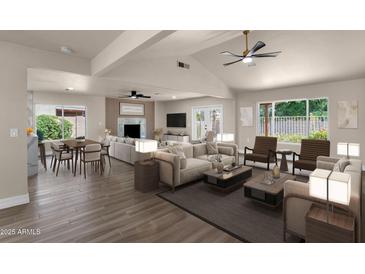 Spacious living room features modern ceiling fan, wood flooring and lots of natural light at 4913 E Acoma Dr, Scottsdale, AZ 85254