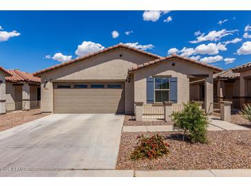 Charming single-story home featuring a desert landscape, tile roof, and an attached two-car garage at 5621 S 30Th Gln, Phoenix, AZ 85041