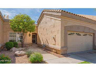 Charming single-story home featuring a well-maintained yard, desert landscaping, and an attached two-car garage at 8839 W Rimrock Dr, Peoria, AZ 85382