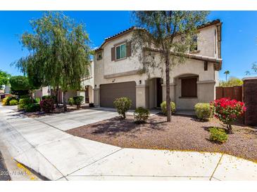 Inviting two-story home boasts stucco siding, a two-car garage, and lovely curb appeal with desert landscaping at 15423 N 22Nd Dr, Phoenix, AZ 85023