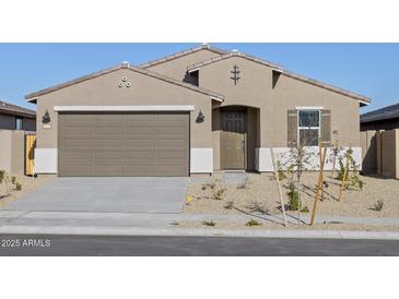 Charming single-story home featuring desert landscaping, a two-car garage and a welcoming front entry at 22514 W Tonopah Dr, Surprise, AZ 85387