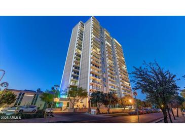 A luxurious high rise boasts multiple balconies against a vibrant blue sky and lush green trees at 2323 N Central Ave # Ph D, Phoenix, AZ 85004