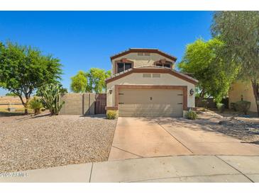 Charming two-story home featuring a two-car garage and desert landscaping at 2454 W Camp River Rd, Queen Creek, AZ 85144