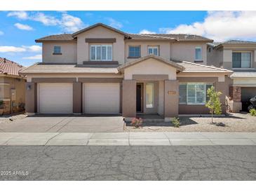 Charming two-story home featuring a three-car garage and a well-maintained, xeriscaped front yard for low maintenance at 2831 W Margy Ct, Phoenix, AZ 85017