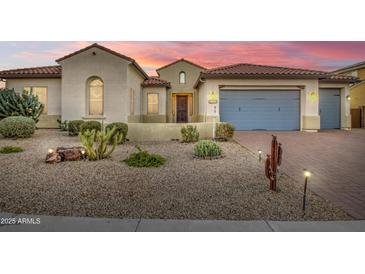 Charming single-story home featuring well-manicured desert landscaping and a three-car garage at 3753 E Ellis St, Mesa, AZ 85205