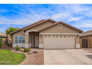 Charming single-story home with a well-maintained lawn, neutral stucco and a two car garage at 3971 E Heather Ct, Gilbert, AZ 85234
