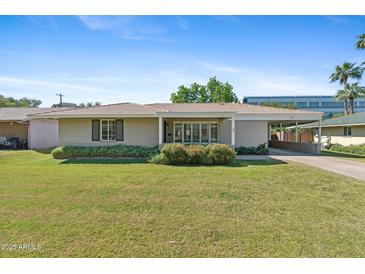 Charming single-story home with a well-manicured lawn, covered entry, and attached carport at 4219 E Catalina Dr, Phoenix, AZ 85018