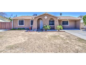 Charming single-story home with a blank canvas front yard ready for personalization and landscape at 6939 W Cambridge Ave, Phoenix, AZ 85035